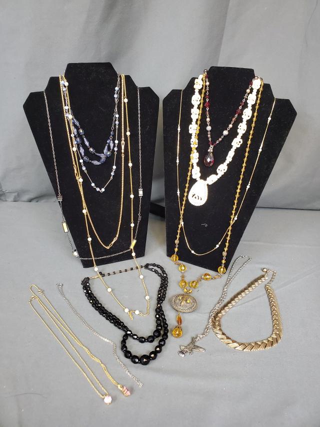 Costume Jewelry Grouping 3 - Necklaces: Costume jewelry grouping 3 includes 15 necklaces: gold tone chain with round pink stone, gold tone chain with emerald cut pink stone, and a silver toned chain. A Trifari gold toned Serpentine necklace