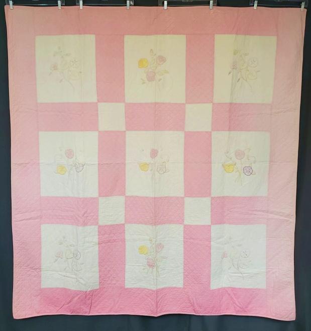 Vintage Floral Applique Quilt c1930s: Vintage c1930s Quilt with Hand Flowers measuring 72x76 inches. Comprised of 9 blocks with hand appliqued and hand embroidered pansies, roses and more, with pink sashing and borders. It is machine piec