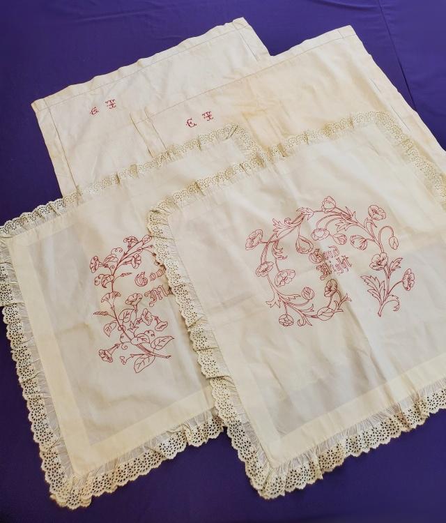 2 Antique Shams & 2 Layovers with Redwork: A pair of antique off white pillow shames with had embroidered CT in one corner in petit point embroidery, fair condition with discoloration and spots. Along with a pair of Victorian Red Work Embroide