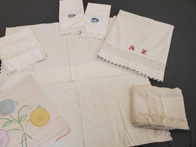Vintage Pillowcase and Sheet Grouping: Group with a small vintage cotton sheet, with seam down the center and monogrammed in red A? 46x78 inches. Along with a pair of embroidered and eyelet bolster style pillow cases that are open on both 