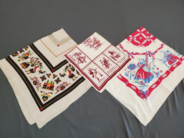 3 Vintage Printed Tablecloths - Group 3: 3 Vintage Printed Tablecloths, Group 3 consists of Colonial Figures, rayon, 44x55, blue spot. PA Dutch Figures, linen, 50x49, storage line discoloration, and spots. Pickwick Theme, rayon, 325x35, stor