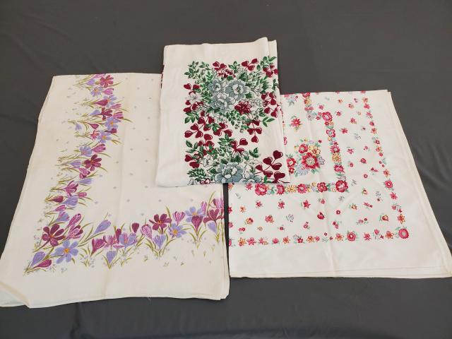 3 Vintage Printed Tablecloths - Group 4: 3 Vintage Printed Tablecloths, Group 4 consists of Small pink, blue, and yellow flowers, cotton, 50x45, spots along edge and corner. Lavender flowers, linen, 48x64, storage line discoloration, and spo