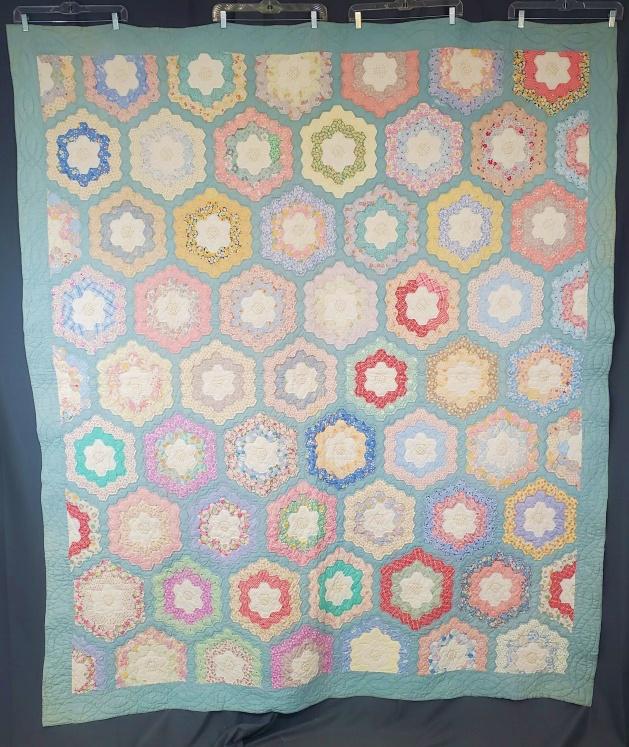 Vintage Grandmother's Flower Garden Quilt: Vintage c1930s Grandmother's Flower Garden Quilt measuring 75x87 inches. Unique in that is uses a yellow print for the flower center, followed by a round of white solid, and then 2 rounds of prints fa