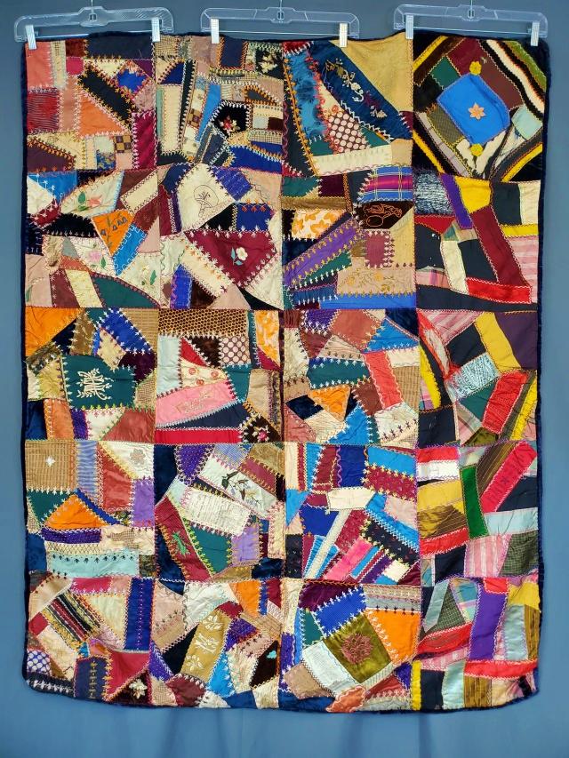 Antique Crazy Quilt with Political Ribbons 1894: Antique crazy quilt measuring 48x60 inches. Comprised of 20 crazy quilt blocks about 12x12, set straight 4 by 5, with no sashing or borders. It is hand pieced and hand embroidered with flowers, figure