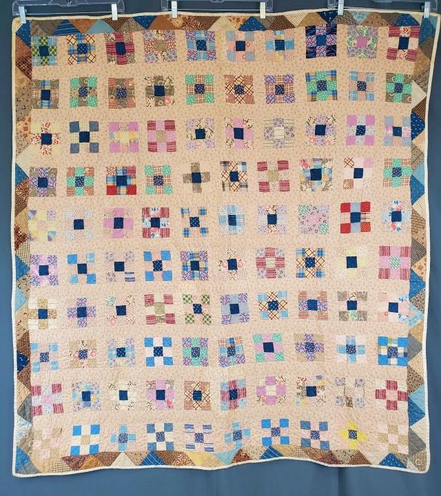 Vintage 1940s Child Size 9 Patch Quilt: Vintage 1940s Child Size 9 Patch Quilt measuring 53x58 inches. May be a multigenerational piece. The 9 patches appear to be c1940s, with many fabrics in the triangle border from 1880s-1890s. It is han