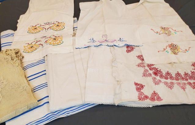 Group of Misc Vintage Bed Linens: Group lot of misc bed linens including 5 hand embroidered pillowcases, a red soutache embroidered pillowcase, a long linen bolster pillow case, a Battenberg lace bedspread, a blue and white striped se