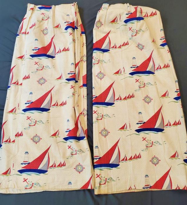 Pair of Vintage Nautical Theme Curtains: Pair of Vintage Cotton Nautical themed curtains with sailboats, lighthouses, an more. In good condition with some dirt scuff and linen marks. They are lined. Each measures 50" long by 60 wide across t