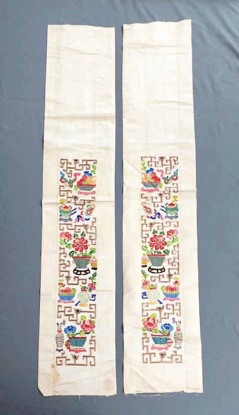 Pair of Chinese Embroidered Silk Sleeve Bands - Flowers: Pair of antique Chinese sleeve bands, ivory silk with hand embroidered flowers and fruits, includes couched metallic threads. Measures approximately 6.5 x 33 inches. In fair condition with spots and d