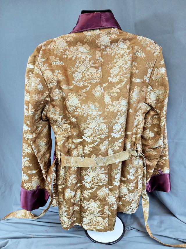 Vintage Japanese Men's Brocade Jacket: Vintage Japanese mens belted brocade jacket with gold brocade with aubergine satin lapels, off white satin lining. Small tag states "Made in Japan." Measures approximately 18 inches across the back, 3