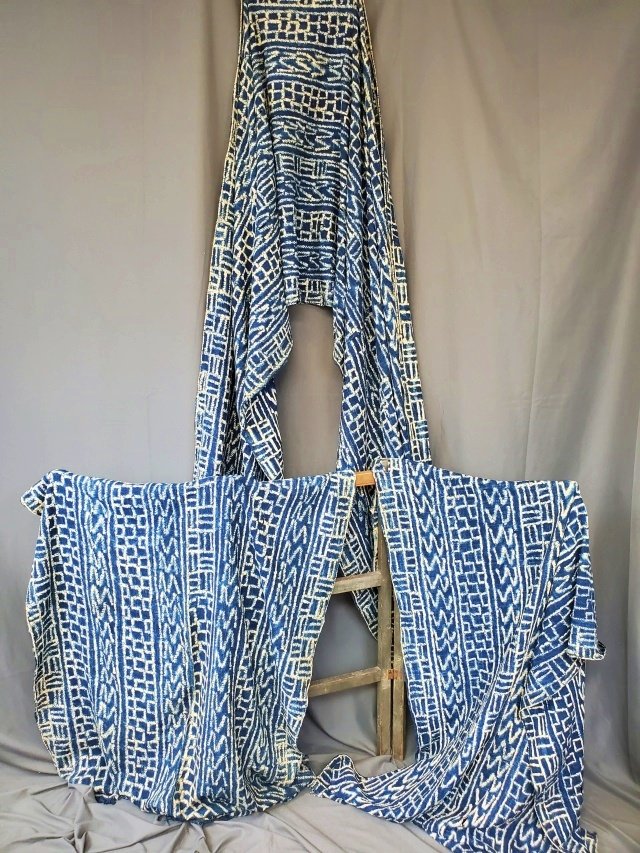 Cameroon African Indigo Handwoven Mens Wrap: Laura Fisher describes the item on her web site as a, "Fascinating indigo handwoven textile from the Cameroons that is resist dyed in differing geometric patterns. Woven in narrow long strips that are