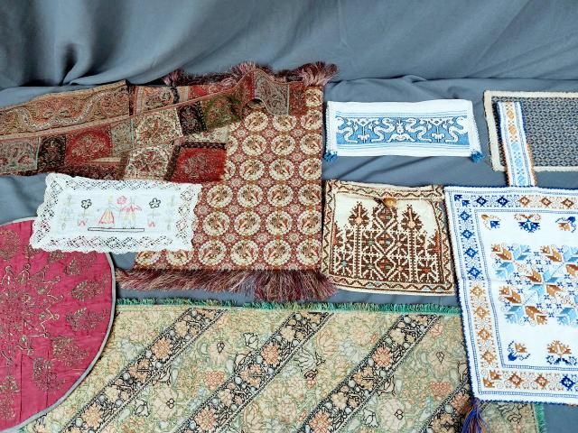 Group of 10 Ethnic Embroidered Textiles: Group of ten textiles includes an Eastern European hand embroidered purse on linen with two small tassels, measuring 9.5 x 12.5 inches with a 6 inch strap; an Eastern European hand embroidered on line