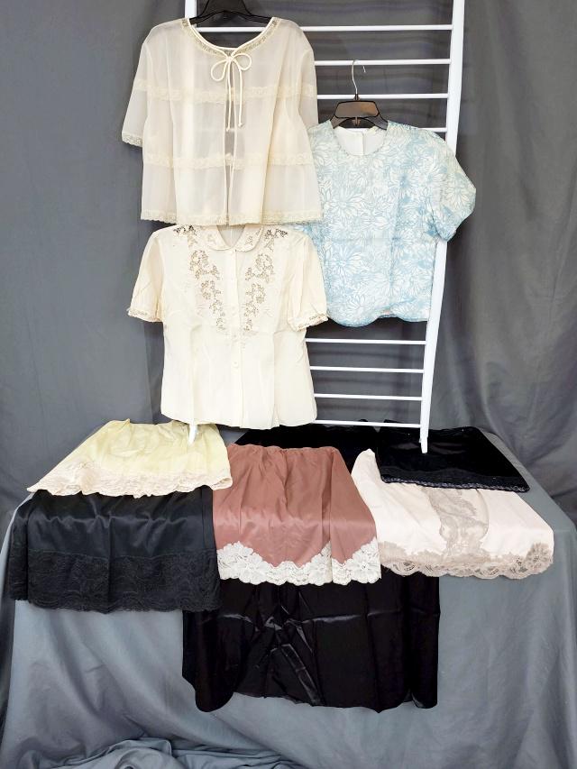 Group of Vintage Slips and Bed Jackets: Group with 6 half slips, 3 in black, 1 yellow, 1 champagne, and 1 brown. And 3 vintage Bed shirts or jackets. The blue one has a tag by Susan Gale, in fair condition with fading. Half slips are by Hol