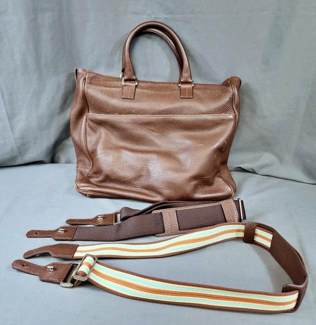 Large Brown Tiffany Pebble Leather Tote Bag: Large Brown Tiffany & Co Pebble Leather Tote Bag with 2 changeable shoulder straps! The bag measures 16x14x6 inches. Marked Tiffany & Co on all the hardware, on the inside, and on the straps. In good 