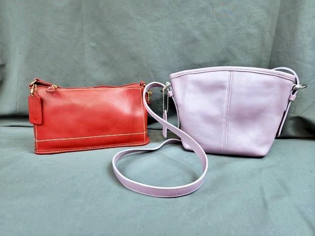 2 Small Leather Coach Bags: 2 Small leather Coach bags one in red, the other in purple. Both have Coach Tag attached, and marked inside Coach with Serial Numbers. Both in very good condition, with only minor marks. Red Mini Bag