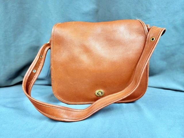 Vintage Brown Coach Leather Bag: Vintage Brown leather Coach bag, c1980s. Measures 11x10x5 inches with large flap over the entire front of the purse. Has the Coach Tag and marked on the inside with Creed and number 0594-300. In good