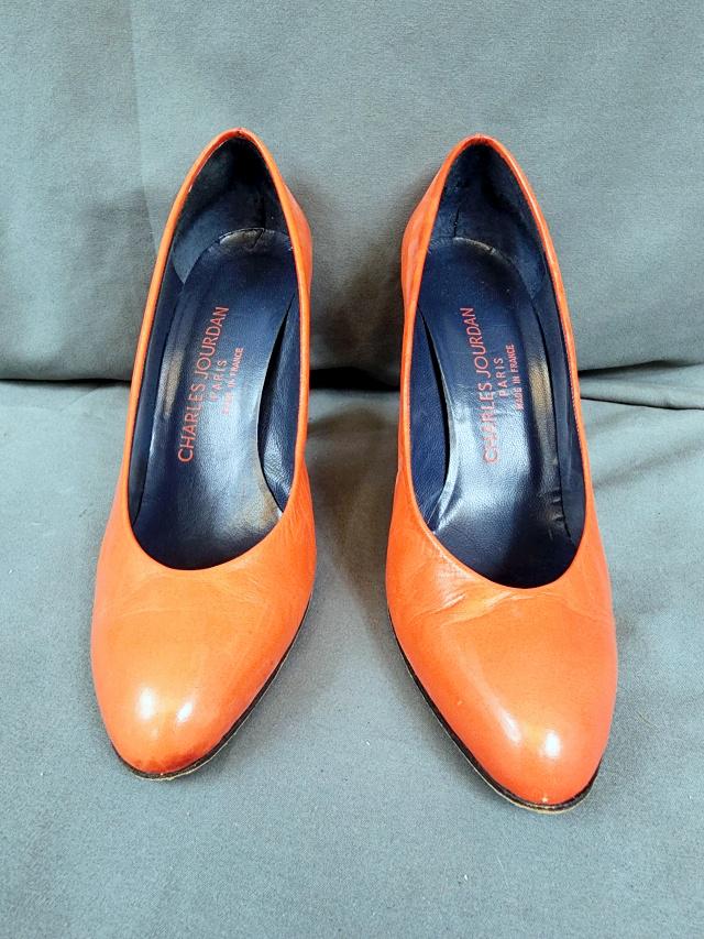 Charles Jourdan Orange High Heel Pumps - 6.5: A pair of orange leather Charles Jourdan high heeled pumps, has a 3.5 inch heel, size 6.5, made in Paris, France, in very good condition with minor scuffs and discolorations. Will ship in Container St