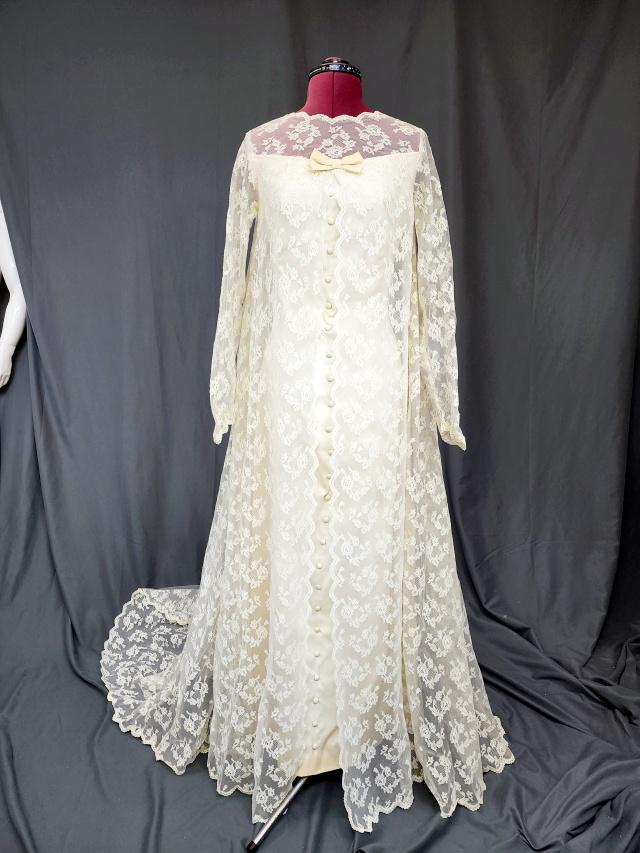Vintage 1969 Satin and Lace Wedding Gown: Vintage 1969 off white wedding gown, slim fit with faux buttons down the center, long lace sleeves, lace above the bosom to the neckline, and spreads out to the sides and down the back creating the tr