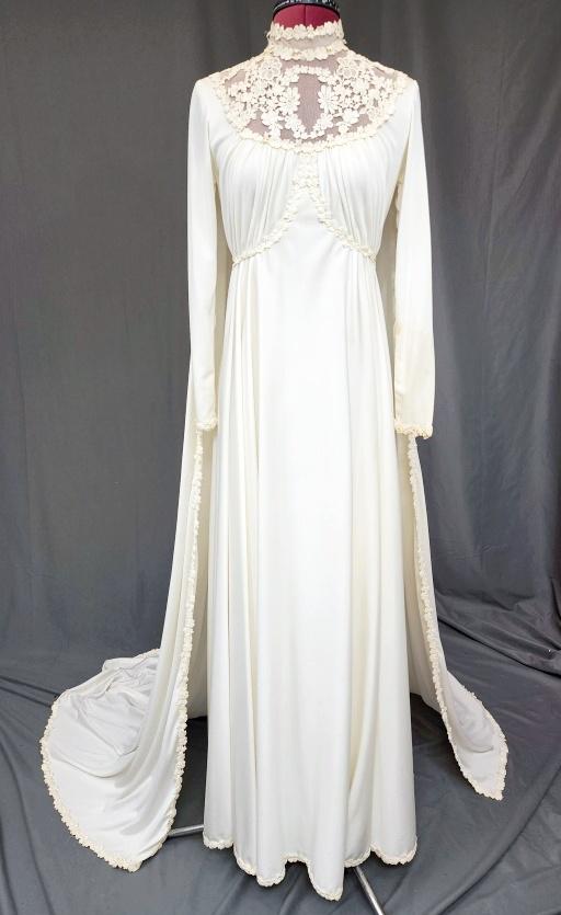 Vintage 1970s Wedding Dress: Vintage Ivory c1970s Wedding Dress with long sleeves, lace collar, and attached train. Zipper up the back. Simple and elegant with lace trim on the cuffs and edges, and outlining the bodice. Measureme