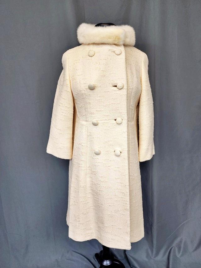 Vintage Brooks of New Brunswick Coat: Vintage Ivory possibly wool Coat, with rabbit fur collar and third quarter sleeves. Tag by Brooks of New Brunswick. Measures flat 14 inches across the shoulders, 37 inches long with 19 inch sleeves. I