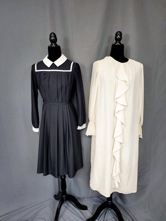 2 Vintage Dresses - JJ Petite: 2 Vintage Ladies Dresses including a black crepe dress with collar white, cuffs and trim. Pleated in the front and ties in the back. Tag by JJ Petite. Measures flat 19b 19w 22h. In good condition with