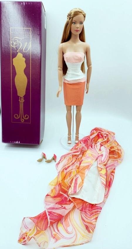 Tonner Tyler Wentworth Cinnamon Swirl ReDressed: Tonner Tyler Wentworth Cinnamon Swirl Doll, T5-TWDD-04 with articulated torso, bendable arms and bendable wrists. She is redressed in a coral and pink and white dress, and pale pink high heel sandals.