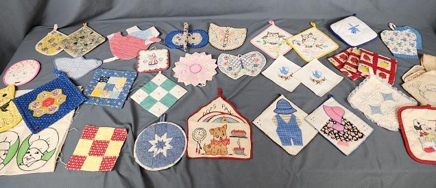 Large Group of Vintage Potholders-Embroidery: 33 Vintage Potholders with hand Embroidery, patchwork, applique, quilted and more. Includes several pairs but mostly singles. Includes 2 with a potholder keeper and a linen potholder keeper with 6 pot