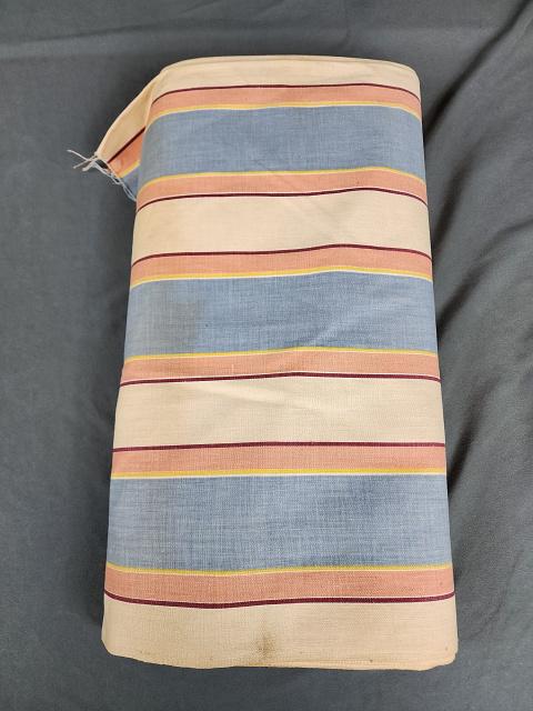 Antique Bolt of Cotton Ticking Fabric: Antique bolt of cotton ticking fabric with thick blue stripes and other subdued colors. Measures 36 inches by 11.5 yards. In overall good condition with some spots and storage discoloration in the cen