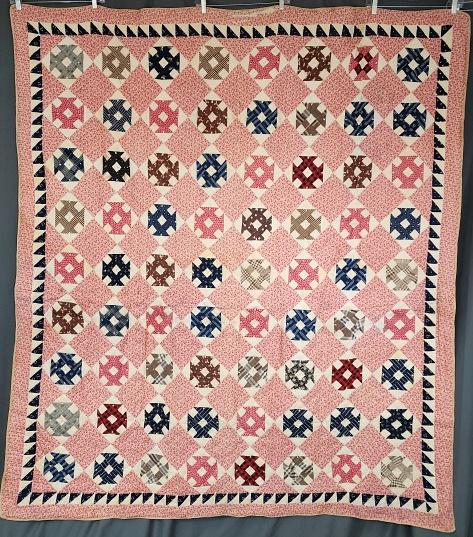 Antique c1900 2-Sided Comfort Quilt: Antique c1900s 2-sided comfort quilt measuring 67" x 78". One side is comprised of churn-dash blocks on point with alternating pink print squares, a saw tooth inner border and a pink print outer borde
