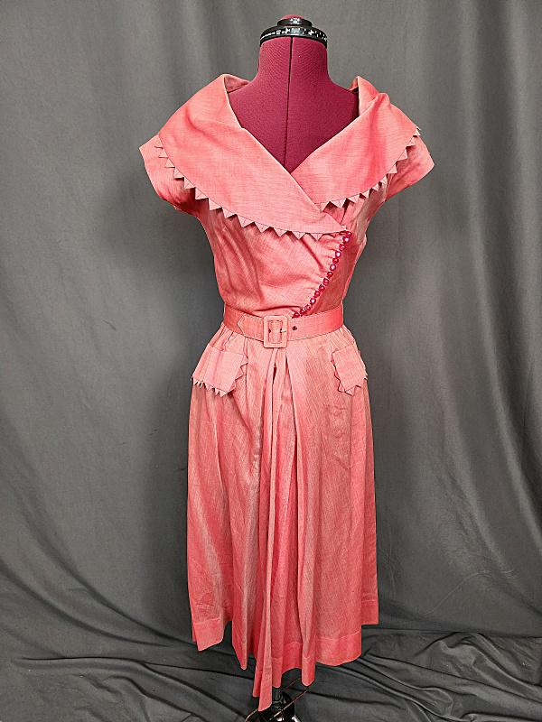 Vintage Ellen Kaye Red Dress: Vintage Ellen Kaye Red Dress with a shimmer quality to it. Small buttons diagonally across the front and a side zipper closure. Collar and pockets are trimmed with prairie points. Matching belt at the