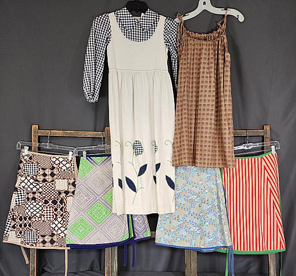 4 Vintage Girls Wrap Skirts & 2 Dresses: 4 Vintage Girls Wrap Skirts & 2 Dresses. 4 Girls cotton wrap skirts, appear to be reversible and adjustable, approximately 22" long, in good condition with some fading and small spots. Along with a gi