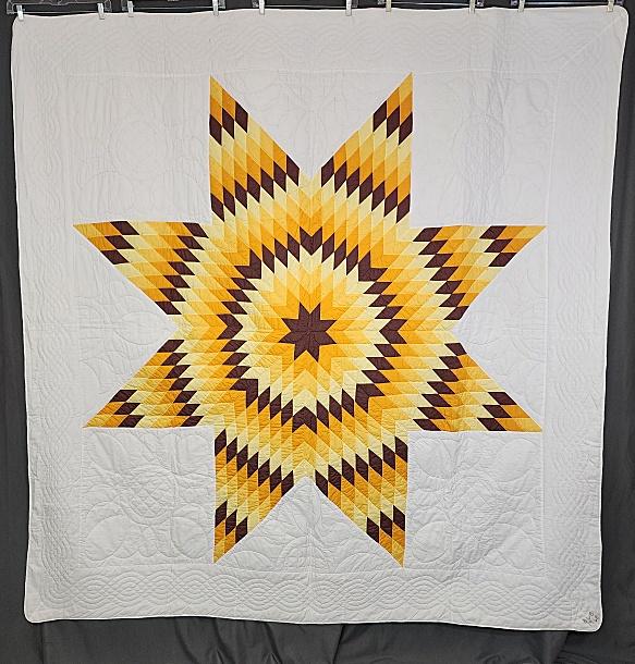 Vintage 1968 Star of Bethlehem with Provenance: Vintage 1968 Star of Bethlehem quilt in orange, brown and yellow. Measures 83" x 84". Star measures about 67" x 67" with a 7" white outer border. It is machine pieced and hand quilted. There is a thin