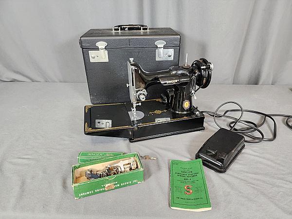 Vintage 1950 Featherweight Sewing Machine: Vintage 1950 Singer Featherweight 221-1 Sewing Machine, looks like it was hardly used. It is in its original case, has 2 keys, instruction manual, oil, box of attachments, and power cord/foot pedal. B