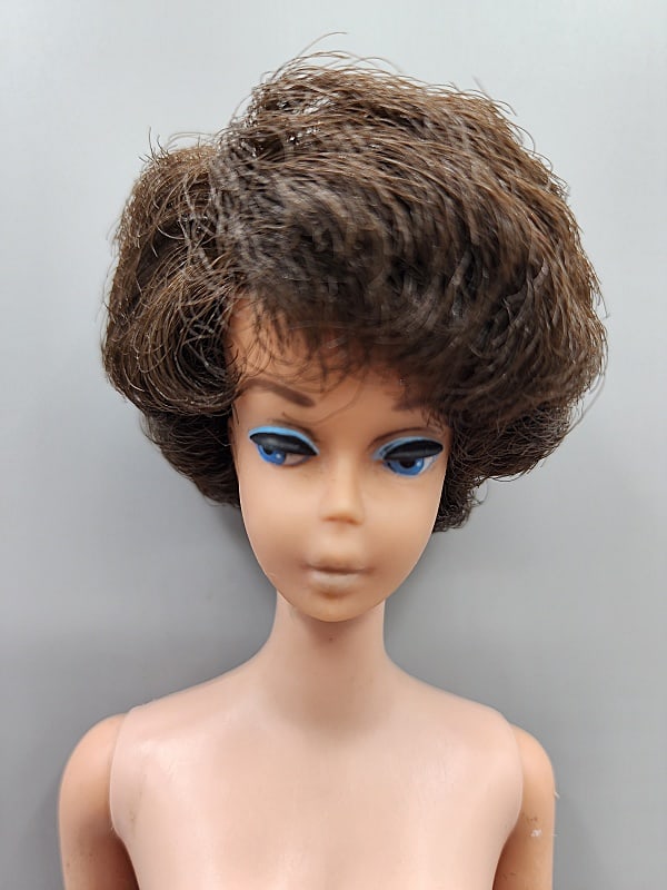 Vintage Barbie - Bubblecut Brunette Nude: Vintage Barbie-Bubblecut Brunette, S/L, Nude. She does have small marks on her legs and arms with some tackiness on her arms. No box, no shoes no earrings, no paperwork. We do our best to describe all