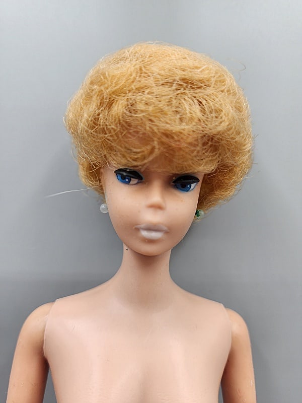 Vintage Barbie - Bubblecut Blonde Nude: Vintage Barbie-Bubblecut Blonde, S/L, Nude. She is wearing her earrings. She has marks on her arms and legs with minor tackiness. No box, no shoes, no paperwork. We do our best to describe all items i