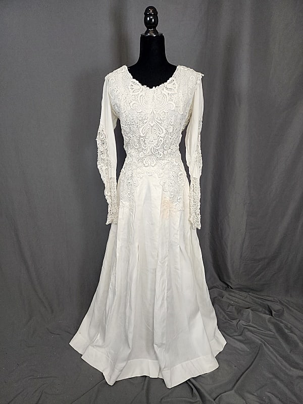 Edwardian Linen and Lace Gown: Edwardian White Linen and Machine Lace Gown with long sleeves. The skirt is pleated. It is very heavy. The back closes with a series of hook and eyes to both the linen and the lace. There is a tag on