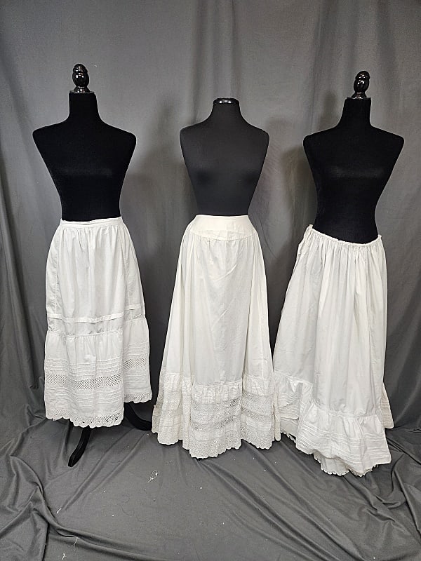 3 Vintage White Petticoats - Group A: 3 Vintage White Petticoats - Group A includes petticoats with pintucks, lace, and embroidery. The first is missing it's closure at the waist and has faint spots. The other 2 tie at the waist and have 
