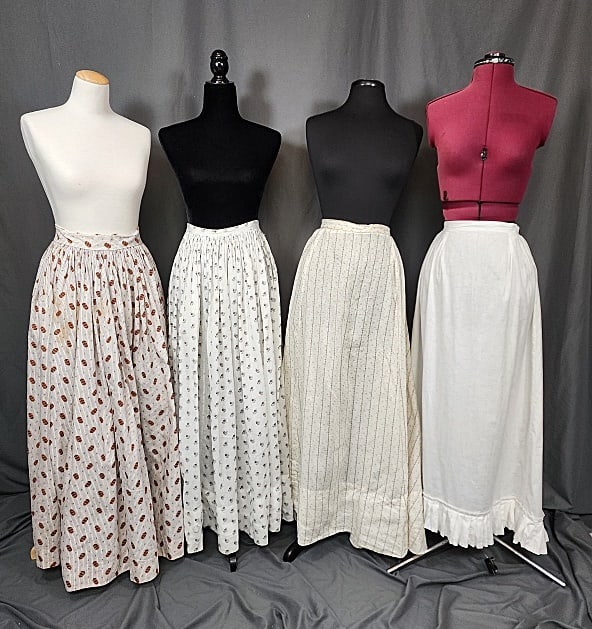 4 Antique 19th C Skirts & Petticoats: 4 Antique 19th C Skirts & Petticoats. Includes a white printed skirt with pocket, box pleated hem, in good condition, print is faded, missing closure, measures laying flat: 12" waist and 39" length; a