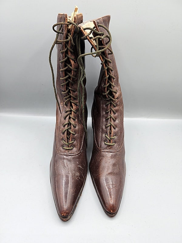 Antique Dark Brown Leather Boots: Antique dark brown leather lace up boots. Measures 11'' L, 3'' at widest point, 2 1/2'' heel. Laces are olive green and in fair condition with scuffs and wear. Heels are starting to split.Please see a