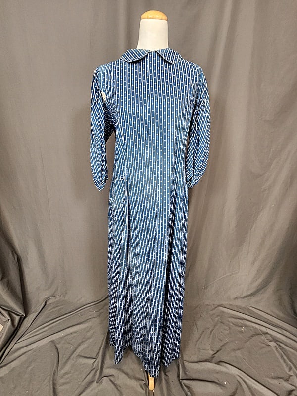 Antique c1900 Indigo Dress: Antique c1900 Indigo Dress. Buttons down the back, attached belt in the back, front pocket, cotton indigo print. Measures laying flat: 21" bust, 22" waist and 38" length. In fair condition with fading