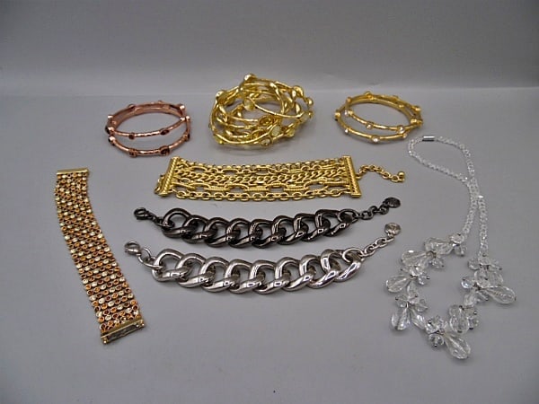 Group of Bangles and Bracelets-Joan Rivers, Graziano: Group of Bangles and Bracelets by Joan Rivers and Graziano. The group includes 8 goldtone metal bangles with light yellow faceted plastic cabochon stations by Graziano measuring 3'' across. 4 hammered