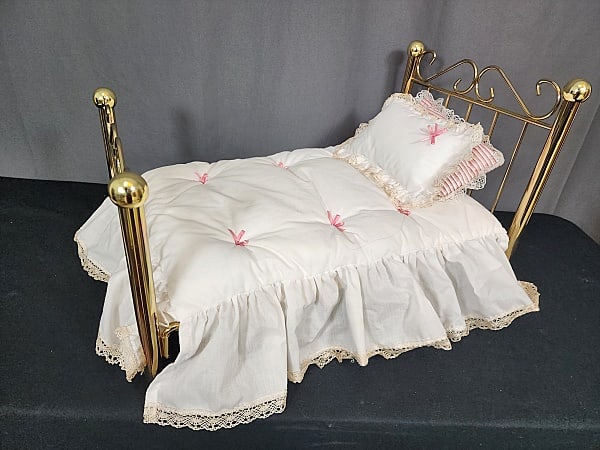 American Girl Samantha's Brass Bed: American Girl Samantha's Brass Bed with mattress, white comfort with pink ribbons and lace edge ruffle, matching pillow with sham, and a pink ticking pillow. Measures 18.5x12x12 inches. This item is d