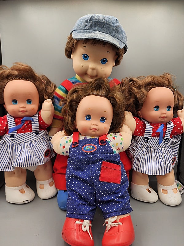 My Buddy with 3 Magic Nursery Dolls: My Buddy with 3 Magic Nursery Dolls. 4 c1990 dolls including a 20" My Buddy Doll with original hat and outfit. In good condition with small marks on face and neck and 3 Magic Nursery Dolls all blue ey