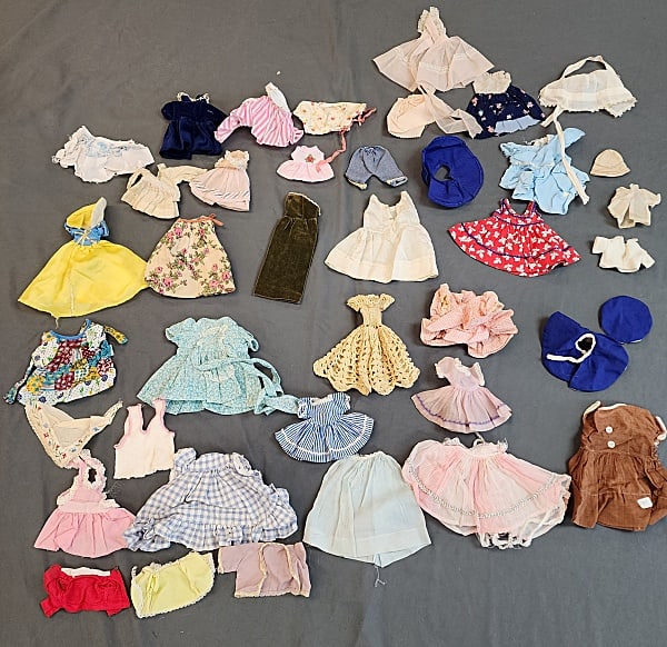 38 Pieces - Vintage Doll Clothing, More - Sm: Group of 38 pieces of doll clothing. Includes dresses, skirts, tops and more. They are in a variety of sizes but are the smaller of the group. In overall fair to good condition with some discoloration
