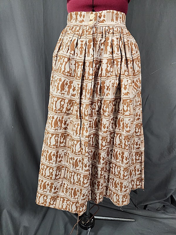 Vintage 1950s Rayon/Linen Ethnic Skirt: Vintage 1950s Rayon/Linen Ethnic Skirt. Beige with brown ethnic print arranged in stripes, positive and negative. Motifs are believed to be African. Skirt closes in front with 2 buttons at waist and a
