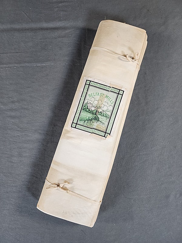 Antique Belfast Mills Linen Old Stock: Antique Belfast Mills Linen Old Stock, found rolled up with its original label. It is plain white linen measuring 35" wide x 14 yards (estimate, based on counting folds). It is unused but does have st