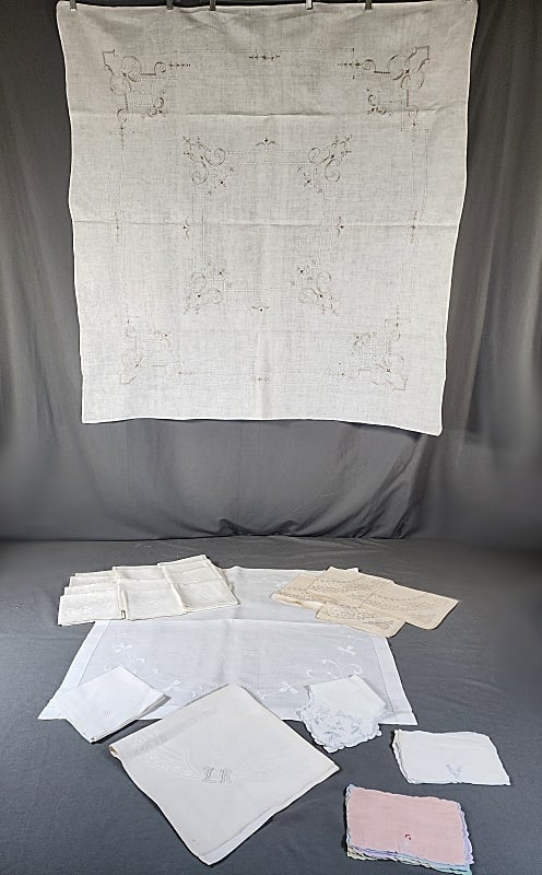 Vintage Tablecloths and Monogrammed Napkins: Group includes 2 small vintage linen tablecloths and several linen napkins. Linen tablecloth with drawnwork, and ecru hand embroidery, 48x50", small wear area by an edge. And a small white linen table