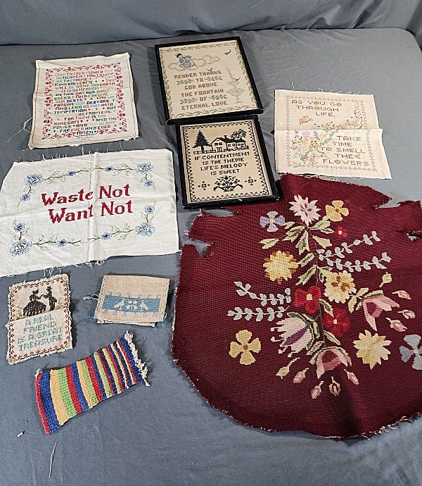 Vintage Needlework Group - Samplers, more: Group includes a salvaged vintage needlepoint seat cove, a small handwoven mat, a small hand embroidered linen purses, a small hand embroidered sampler, 3 unframed samplers including the Lord's Prayer