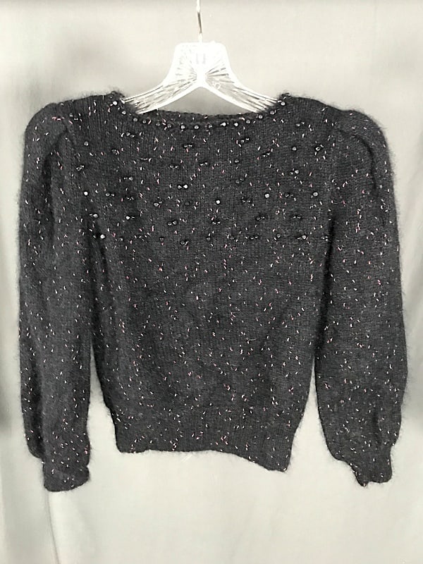 Vintage Ladies Handmade Black Sweater c1980: Vintage Ladies Handmade Black Sweater c1980. This classic 80's black sweater features a soft black yarn peppered with pink and orange, shoulder pads, and black square beads made of wood applied to the