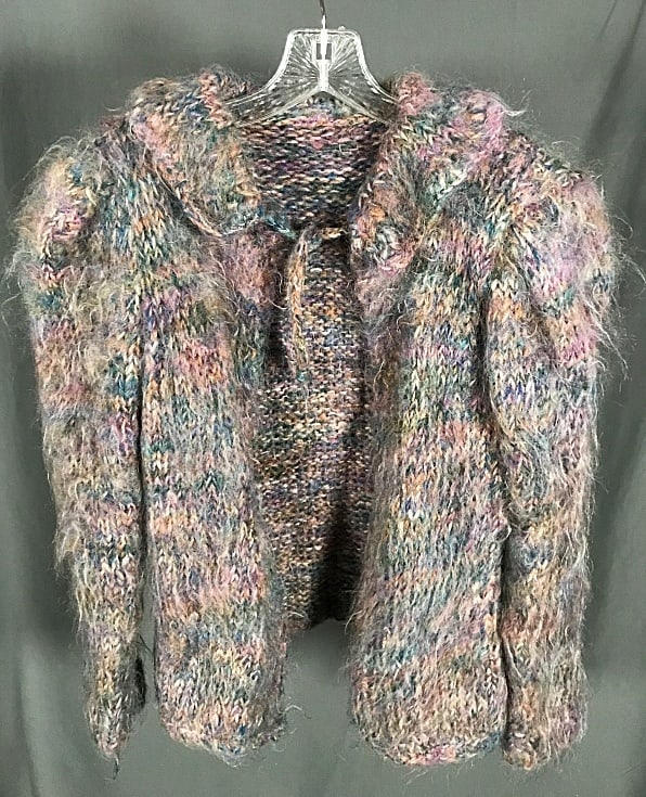 Vintage Ladies Handmade Cardigan c1980: Vintage Ladies Handmade Cardigan c1980. Featuring bloused shoulders, a fold down collar, and necktie all made of a brushed thick yarn in tones of blue,green,purple, and tan. Fiber content unknown. Mea