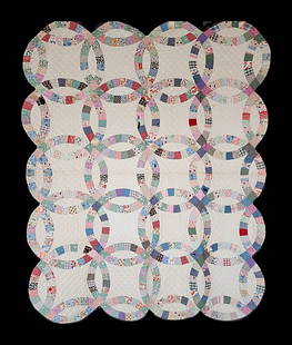 Vintage c1940 Double Wedding Ring Quilt: Vintage c1940 Double Wedding Ring Quilt Measuring 55 by 68 inches. It is comprised of 20 interlocking rings, 17 1/2 inches in diameter, 4 by 5. It is hand pieced and hand quilted. Thin cotton batting